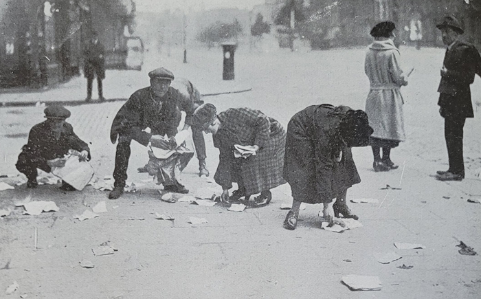 People picking up documents blown out of the Four Courts during the Battle of Dublin 